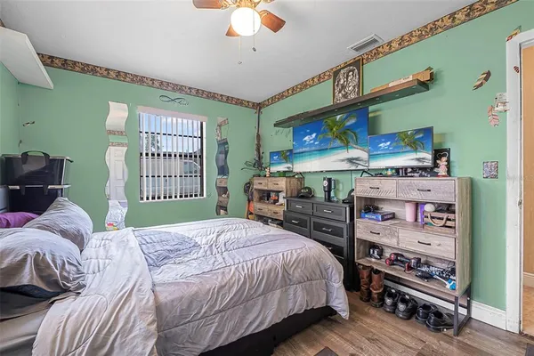 a bedroom with a bed and a bookshelf