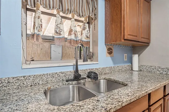 a kitchen with stainless steel appliances granite countertop a stove and a refrigerator