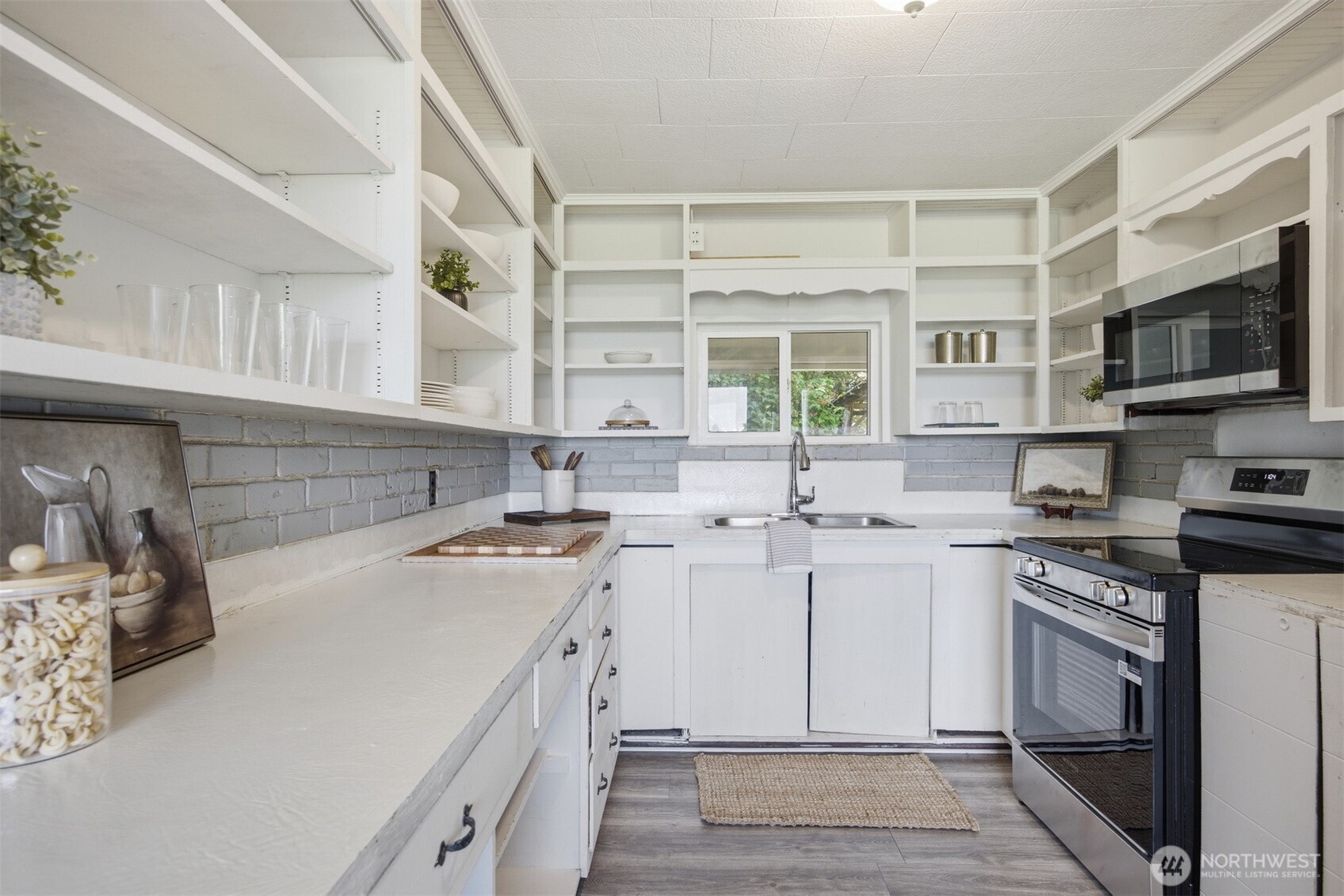 6791 Noon Road Everson, WA 98247 - Photo 13 of 38 a kitchen with a sink stove and cabinets