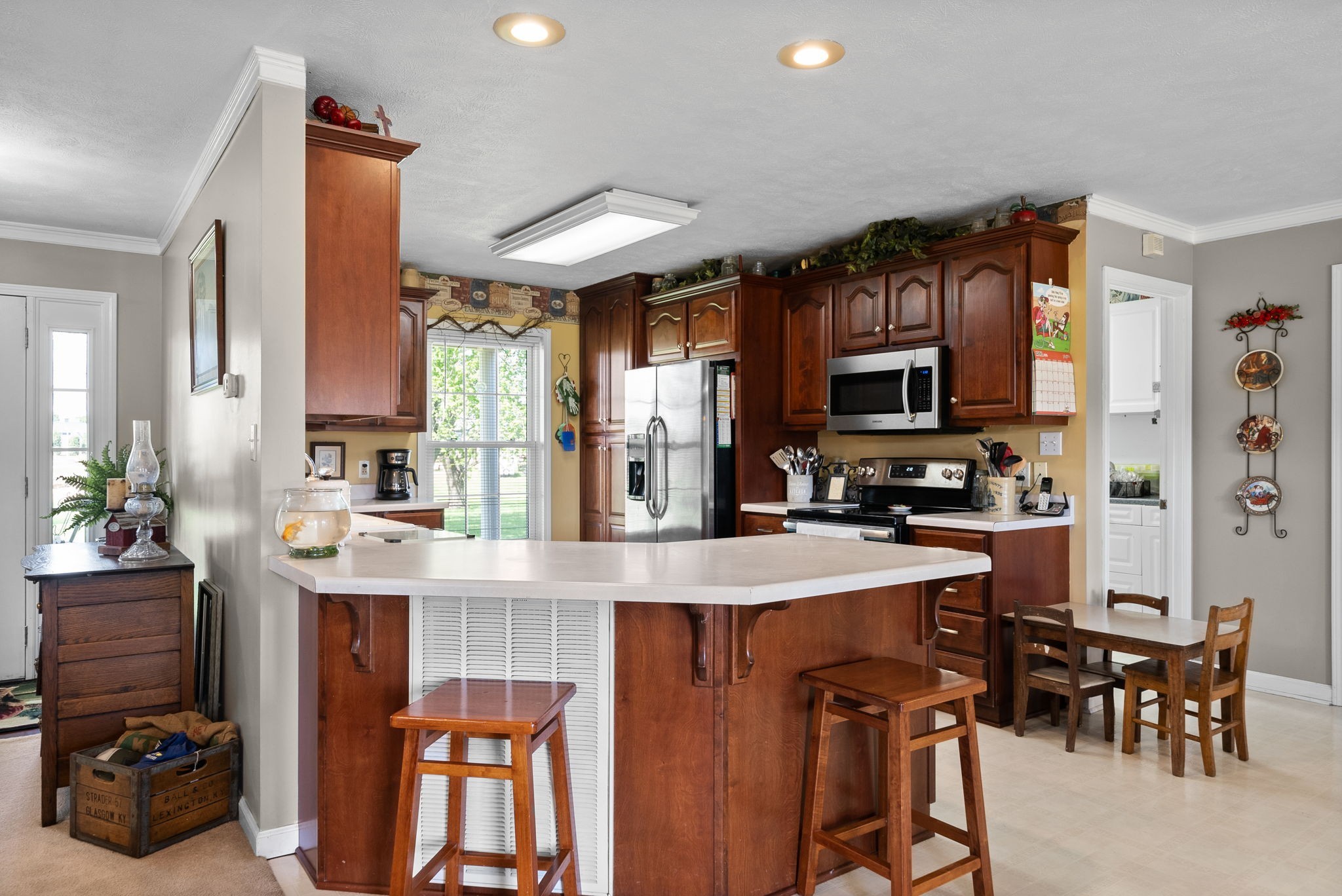 286 Tower Street Guthrie, KY 42234 - Photo 14 of 48 a kitchen with stainless steel appliances granite countertop a stove top oven a sink a dining table and chairs with wooden floor