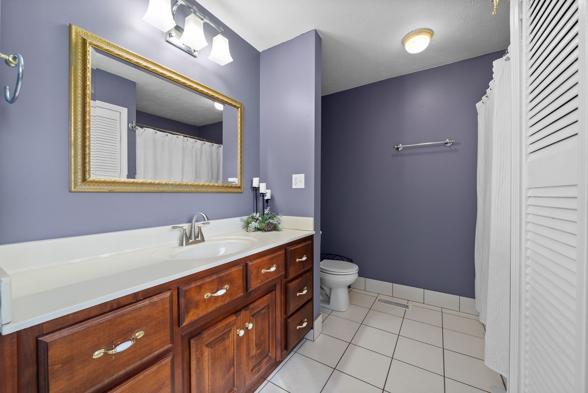 286 Tower Street Guthrie, KY 42234 - Photo 20 of 48 a spacious bathroom with a double vanity sink a toilet and a mirror