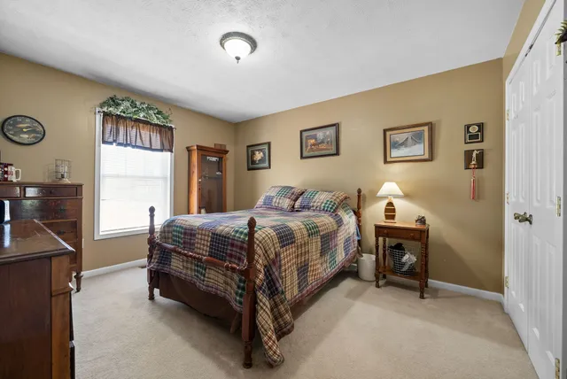 a spacious bedroom with a bed and a table in it