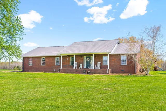 an aerial view of a house with big yard