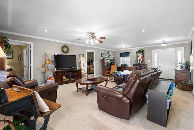 a living room with furniture and a flat screen tv