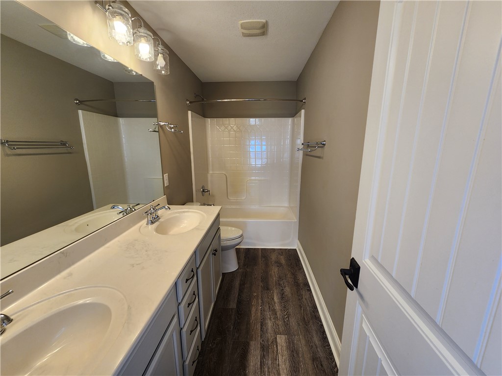 7441 Dodson Road Brookville, OH 45309 - Photo 45 of 50 This updated bathroom features a dual vanity and a tub with shower, offering comfort and style.