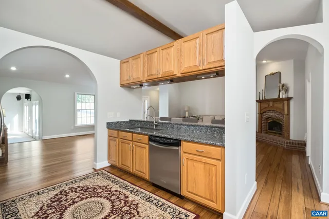 a kitchen with granite countertop a sink and cabinets