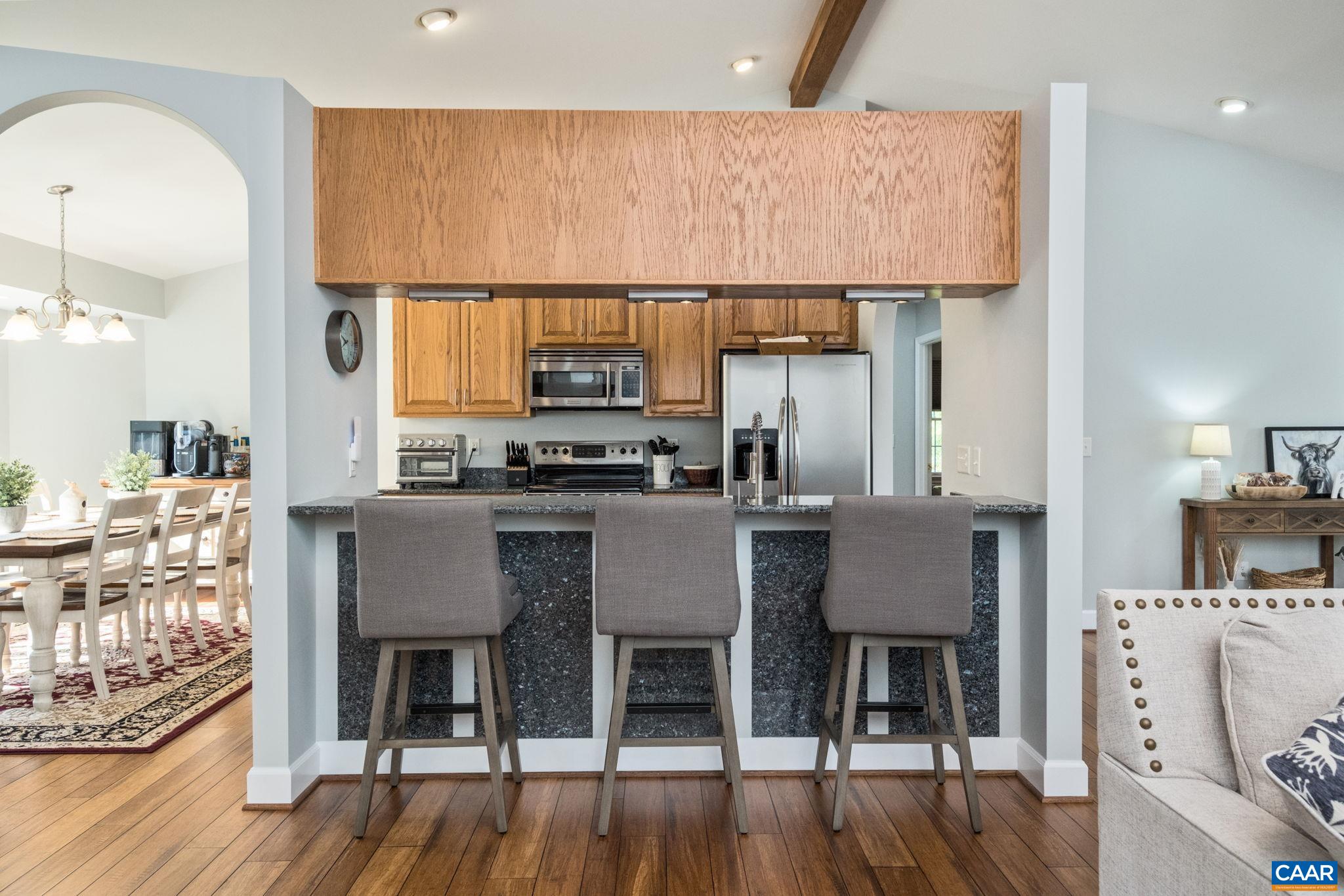 105 Squirrel Path Stanardsville, VA 22973 - Photo 26 of 67 a kitchen with a table chairs and a stove