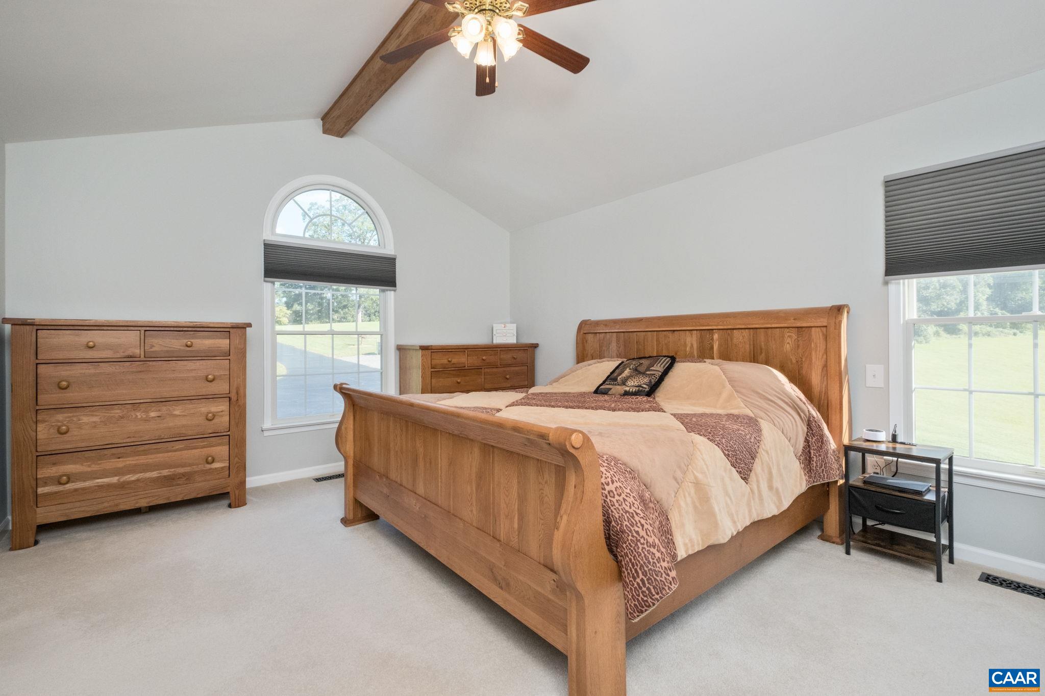 105 Squirrel Path Stanardsville, VA 22973 - Photo 31 of 67 a bedroom with a bed a dresser and a window