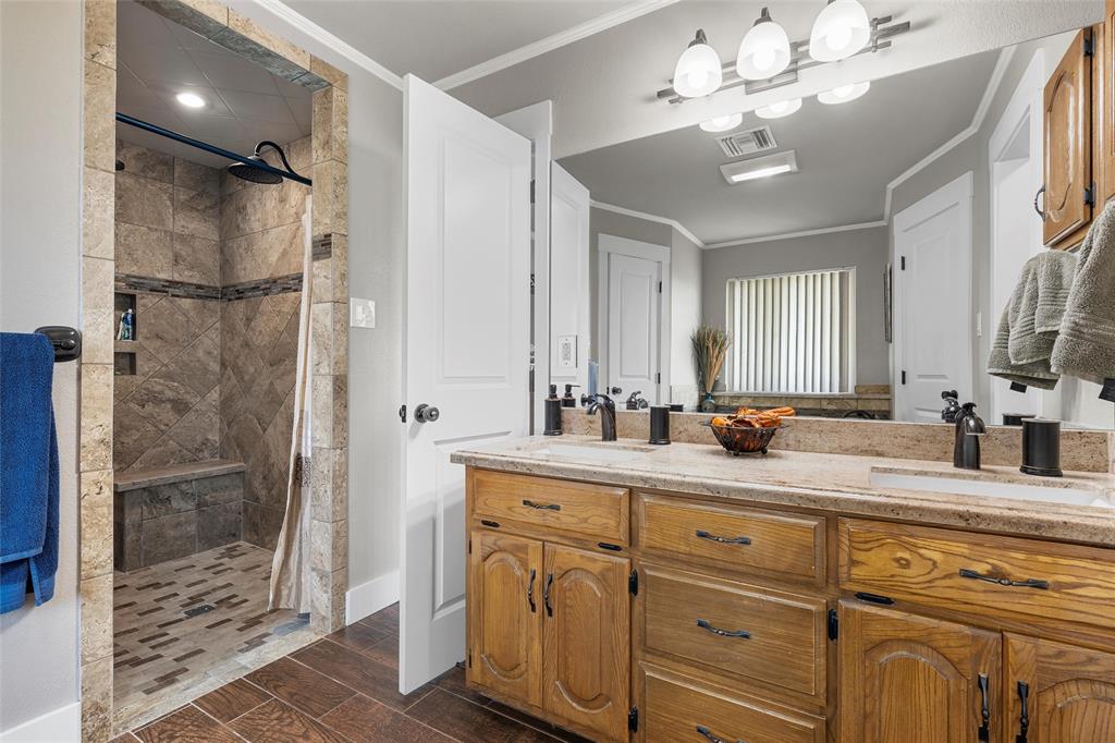 11541 Old Dallas Road West, TX 76691 - Photo 14 of 39 a bathroom with a double vanity sink mirror and shower
