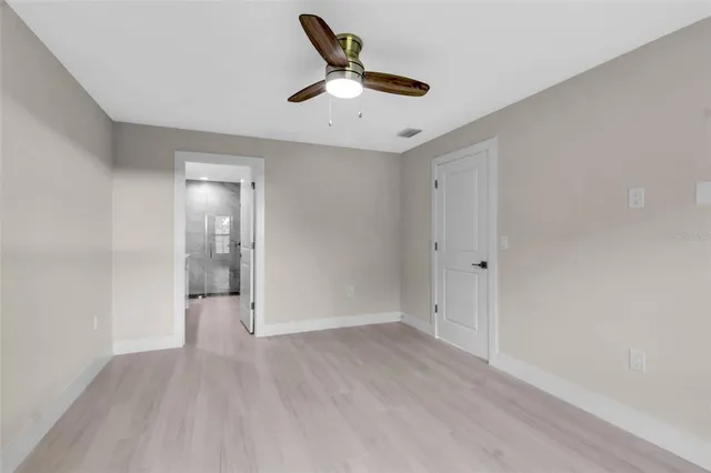 a view of an empty room and wooden floor