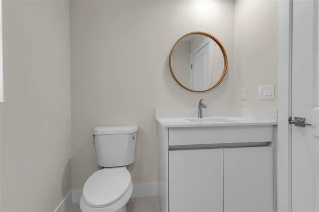 a bathroom with a toilet a sink and a mirror