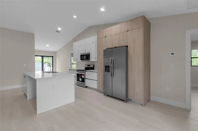 a kitchen with stainless steel appliances a refrigerator and a stove