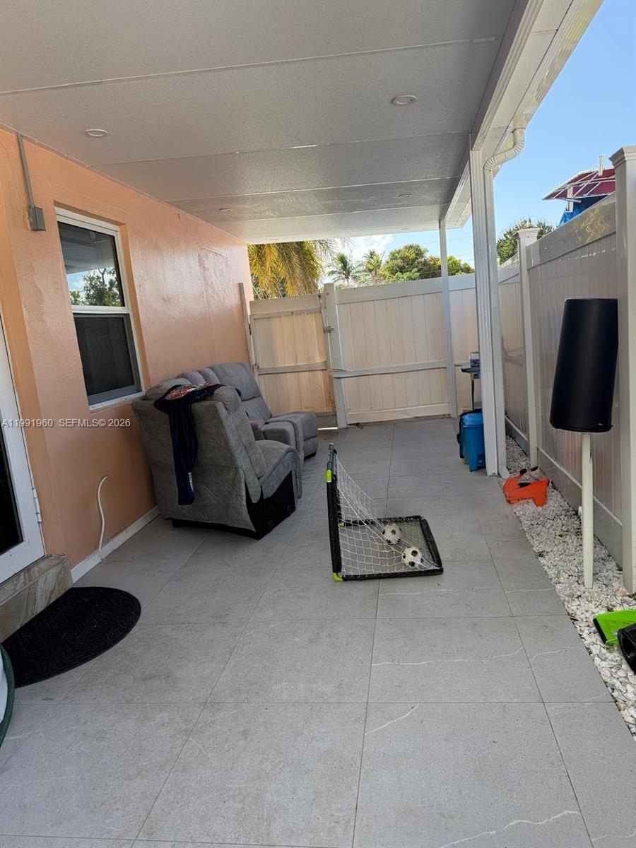 625 East 8th Lane Hialeah, FL 33010 - Photo 11 of 46 a room with furniture and a flat screen tv