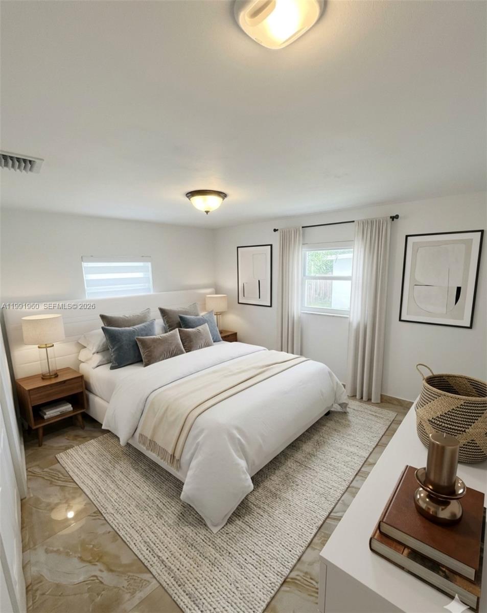 625 East 8th Lane Hialeah, FL 33010 - Photo 13 of 46 a bedroom with a large bed and a window