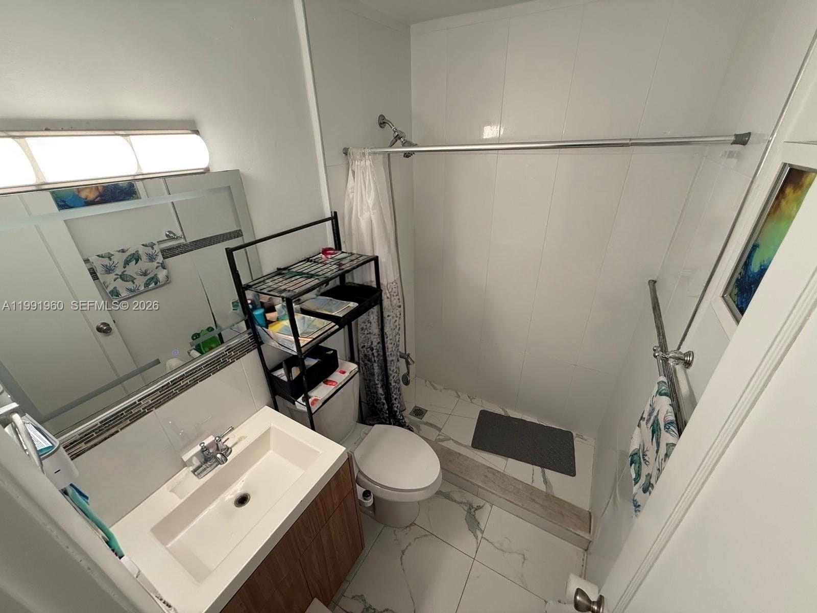 625 East 8th Lane Hialeah, FL 33010 - Photo 17 of 46 a bathroom with a sink a toilet and shower