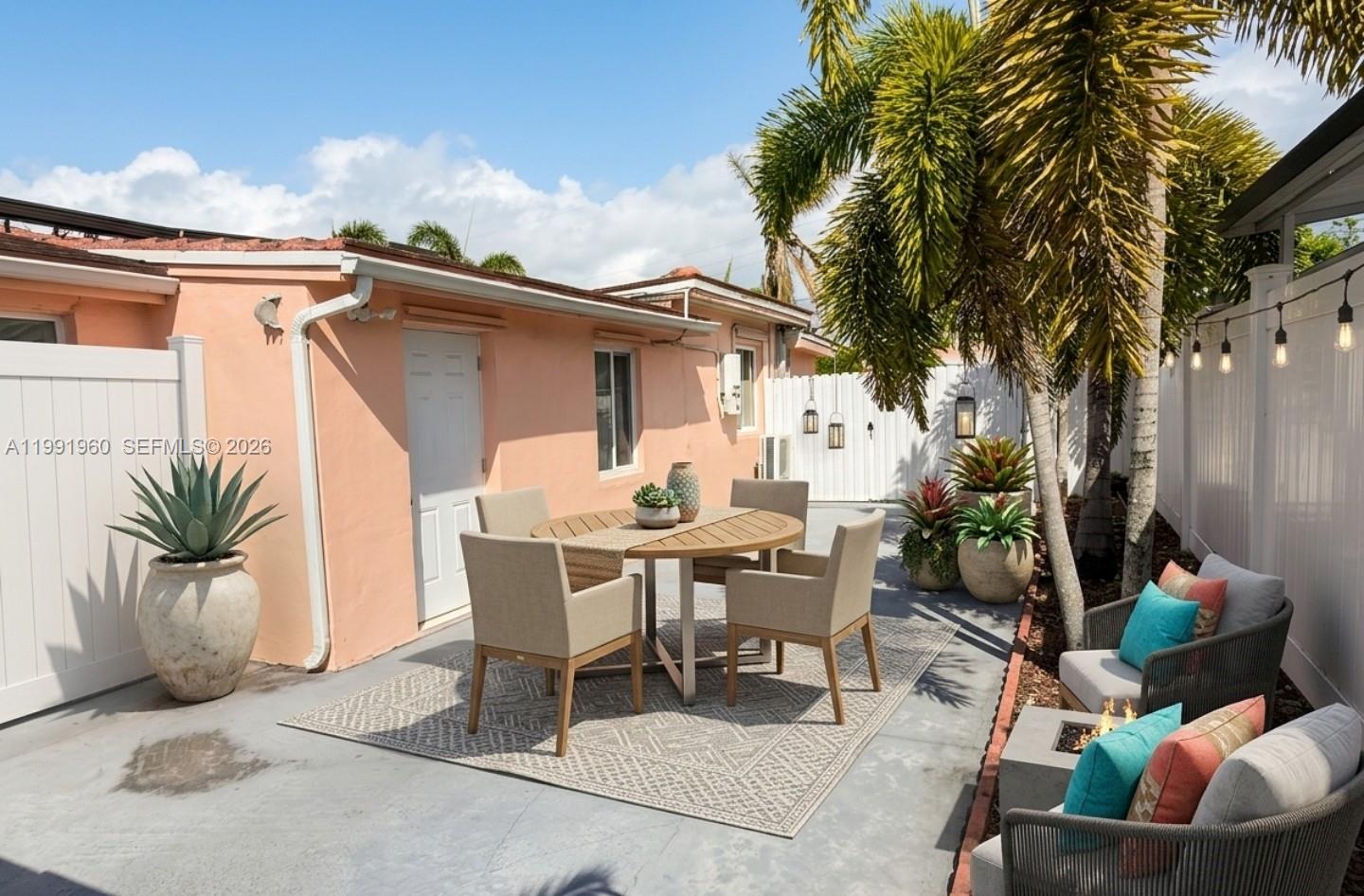 625 East 8th Lane Hialeah, FL 33010 - Photo 19 of 46 a view of a patio with table and chairs and potted plants with sky view