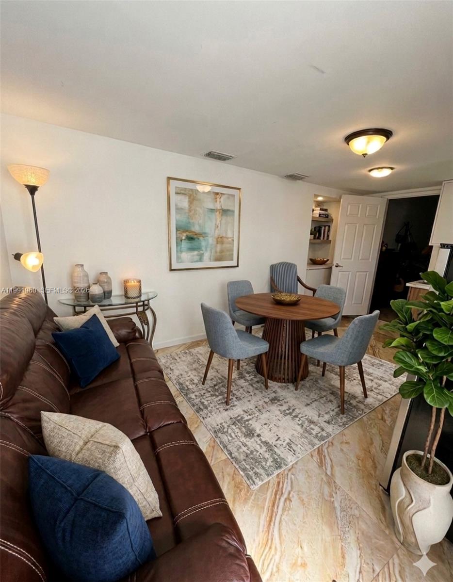 625 East 8th Lane Hialeah, FL 33010 - Photo 20 of 46 a living room with furniture and wooden floor
