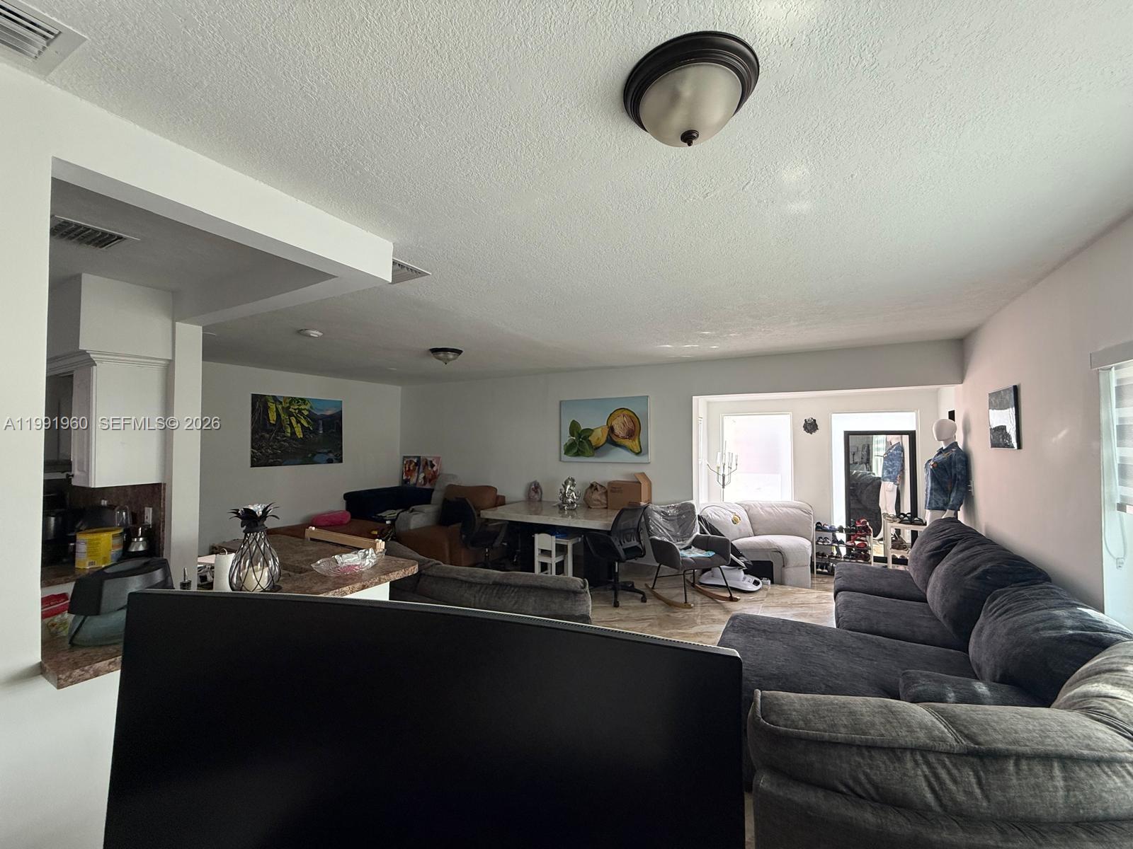 625 East 8th Lane Hialeah, FL 33010 - Photo 22 of 46 a living room with furniture kitchen view and a window