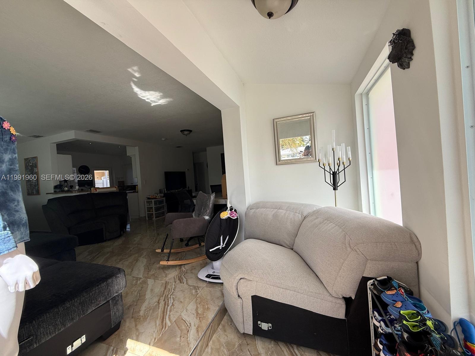 625 East 8th Lane Hialeah, FL 33010 - Photo 23 of 46 a living room with furniture and a flat screen tv