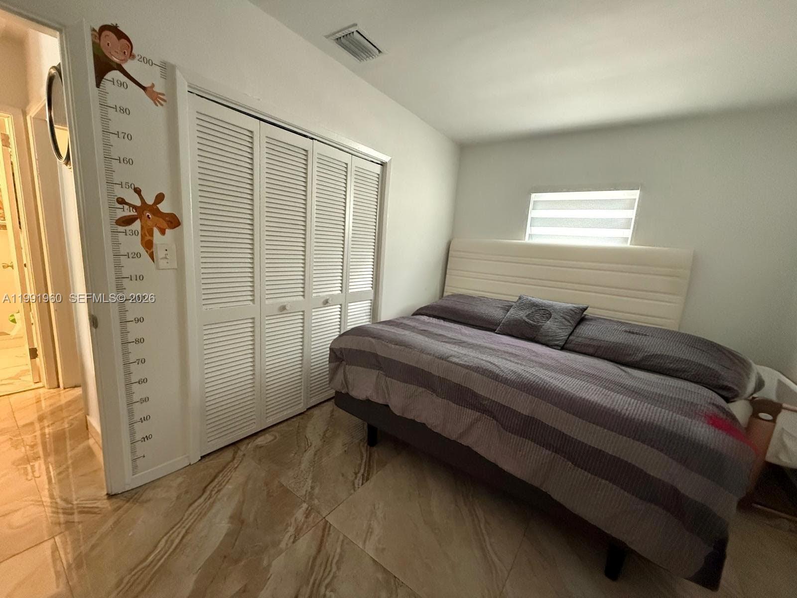 625 East 8th Lane Hialeah, FL 33010 - Photo 24 of 46 a bedroom with a bed and a window