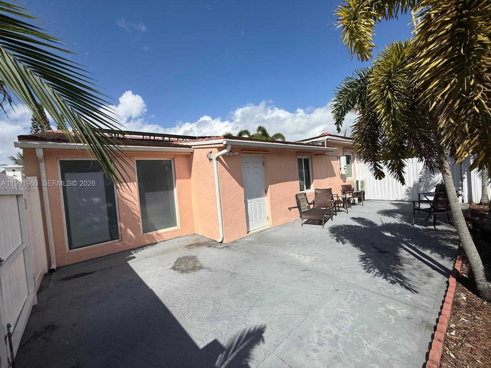 625 East 8th Lane Hialeah, FL 33010 - Photo 25 of 46 a front view of a house with a yard