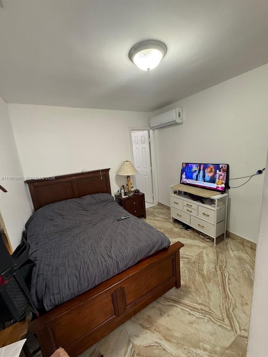 625 East 8th Lane Hialeah, FL 33010 - Photo 32 of 46 a spacious bedroom with a bed and a couch