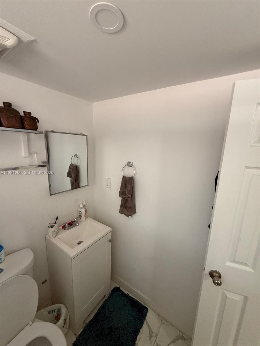 625 East 8th Lane Hialeah, FL 33010 - Photo 33 of 46 a bathroom with a sink toilet and vanity