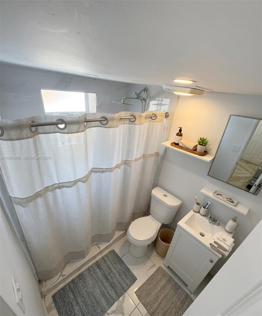 625 East 8th Lane Hialeah, FL 33010 - Photo 34 of 46 a bathroom with a toilet and a shower