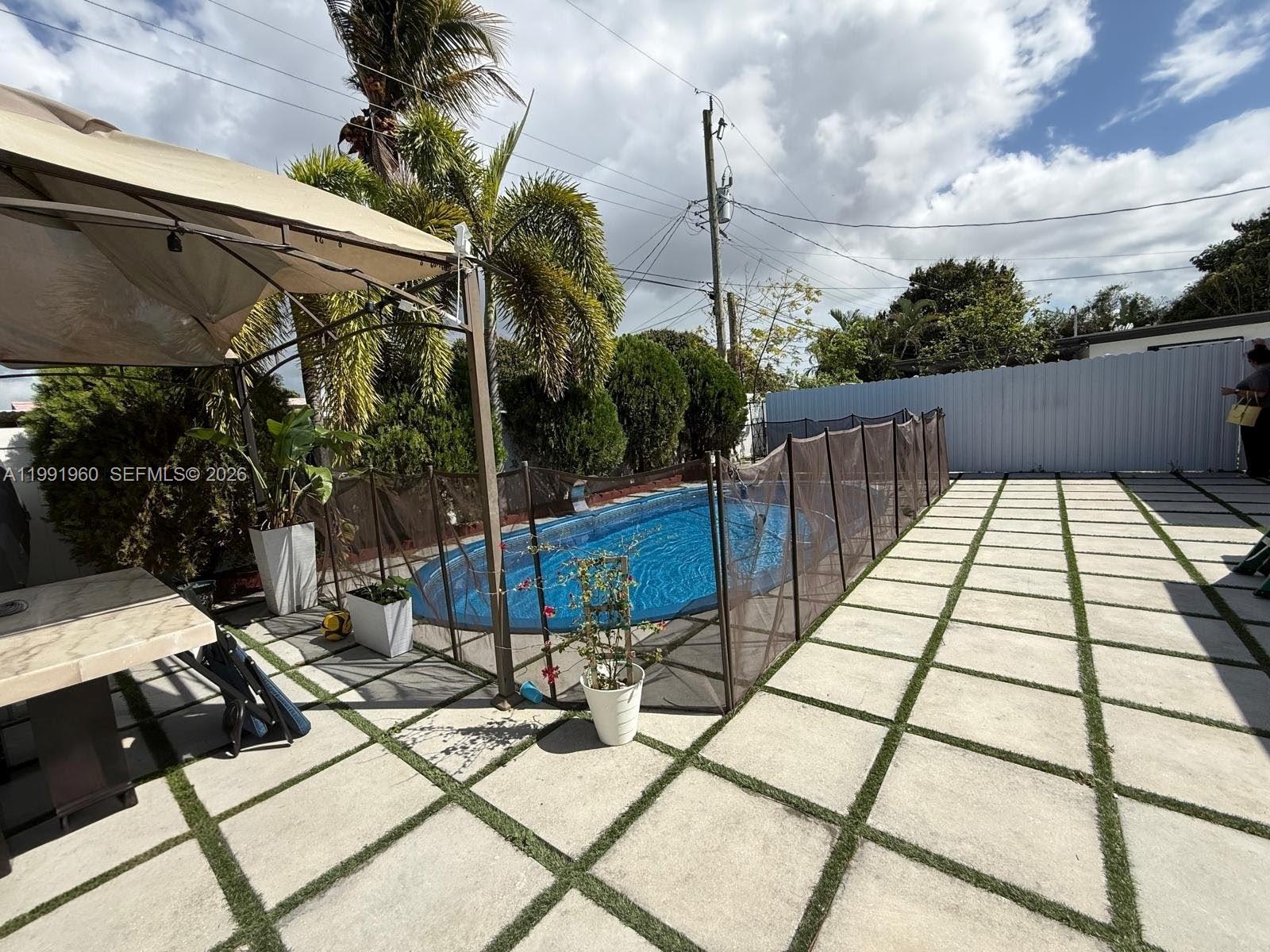625 East 8th Lane Hialeah, FL 33010 - Photo 40 of 46 a view of a patio with a table chairs and potted plants