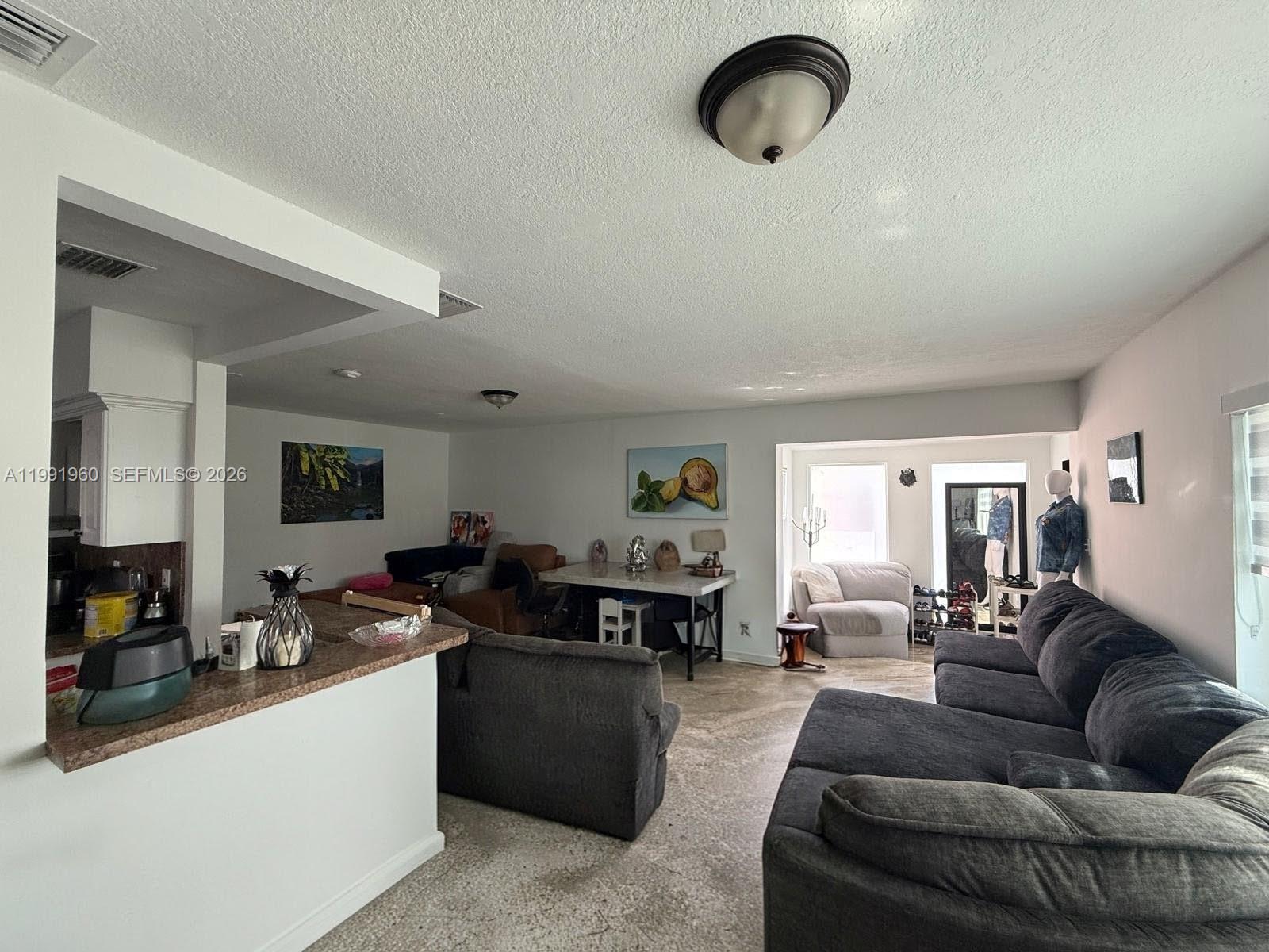 625 East 8th Lane Hialeah, FL 33010 - Photo 5 of 46 a living room with furniture kitchen view and a window