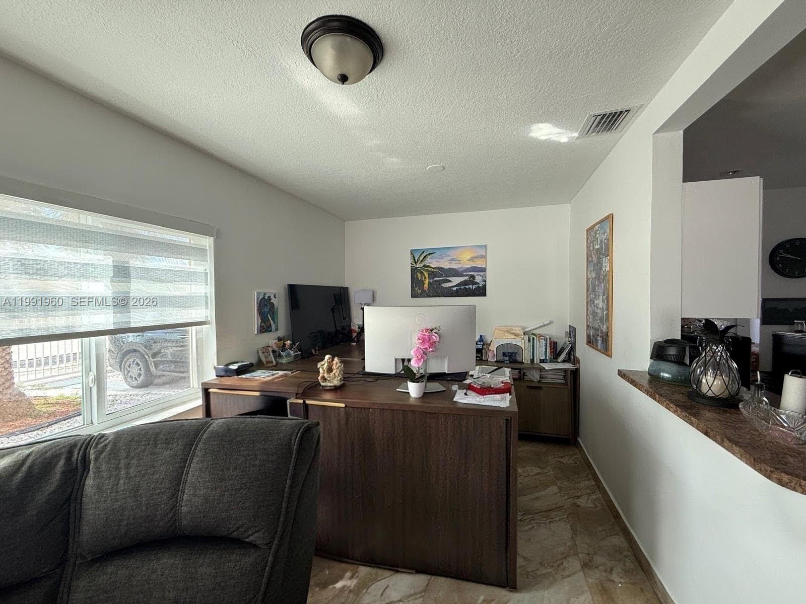 625 East 8th Lane Hialeah, FL 33010 - Photo 7 of 46 a living room with furniture and a flat screen tv
