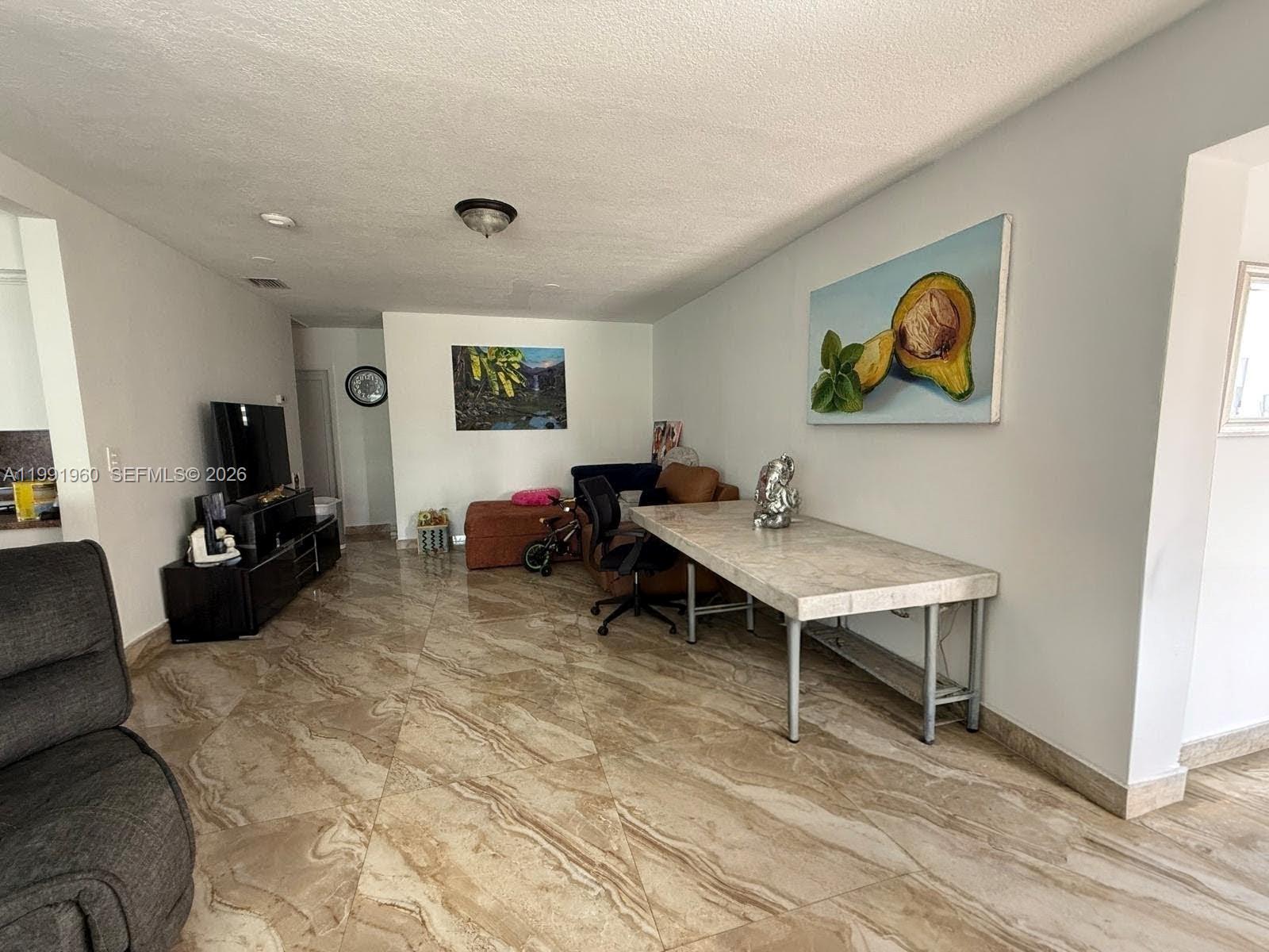 625 East 8th Lane Hialeah, FL 33010 - Photo 8 of 46 a living room with furniture and a flat screen tv