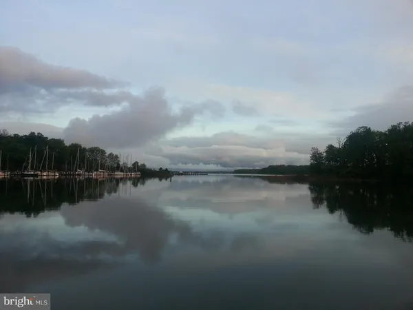 a view of a lake with houses in the back