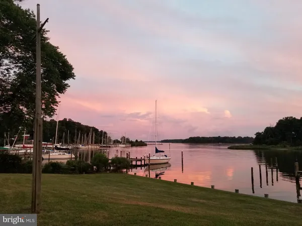 a kitchen with white cabinets stainless steel appliances and sink