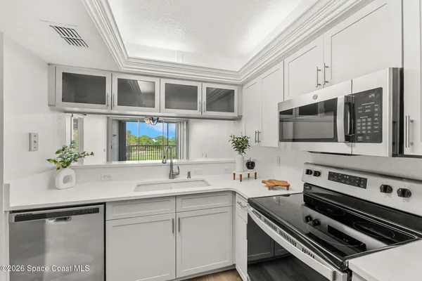 a kitchen with stainless steel appliances a stove microwave and cabinets