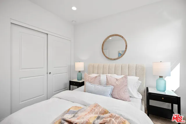 a bedroom with a bed and a lamp