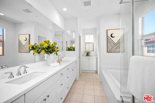 a bathroom with a granite countertop sink a mirror and a shower