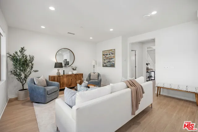 a living room with furniture and a potted plant