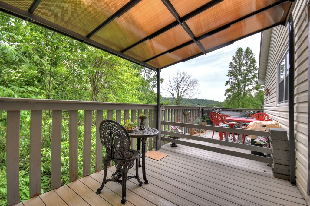 1359 Salem Road Mineral Bluff, GA 30559 - Photo 17 of 18 a view of a balcony with chairs and wooden fence