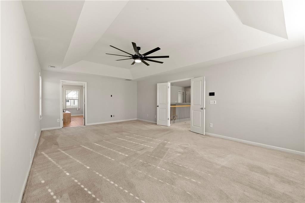 3181 Day Break Lane Dacula, GA 30019 - Photo 13 of 25 a view of an empty room with a ceiling fan