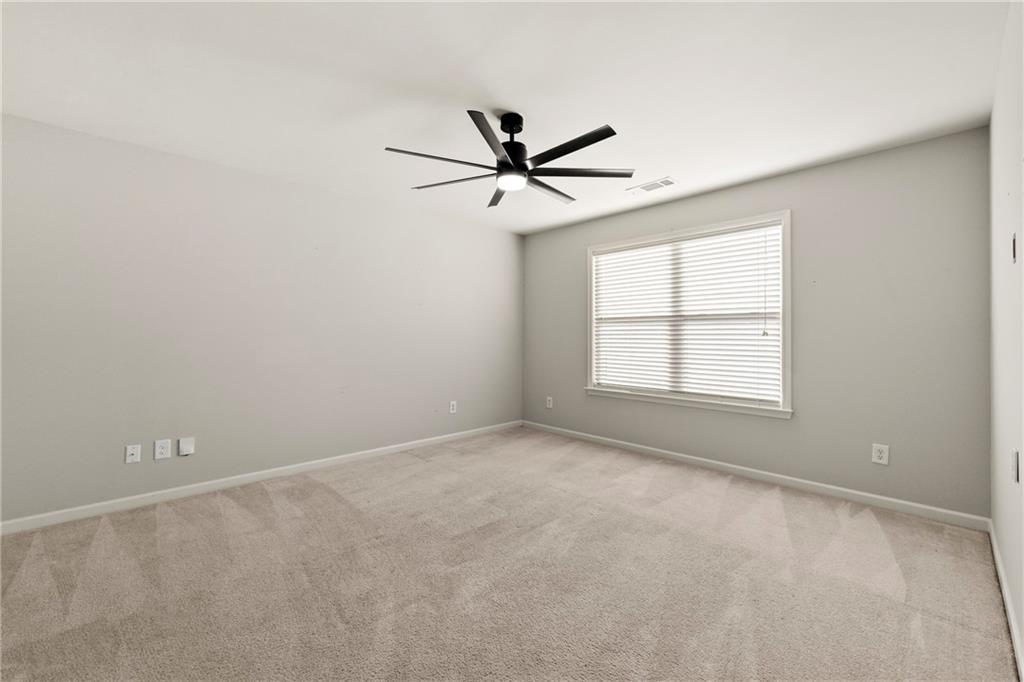 3181 Day Break Lane Dacula, GA 30019 - Photo 15 of 25 an empty room with a window and a fan