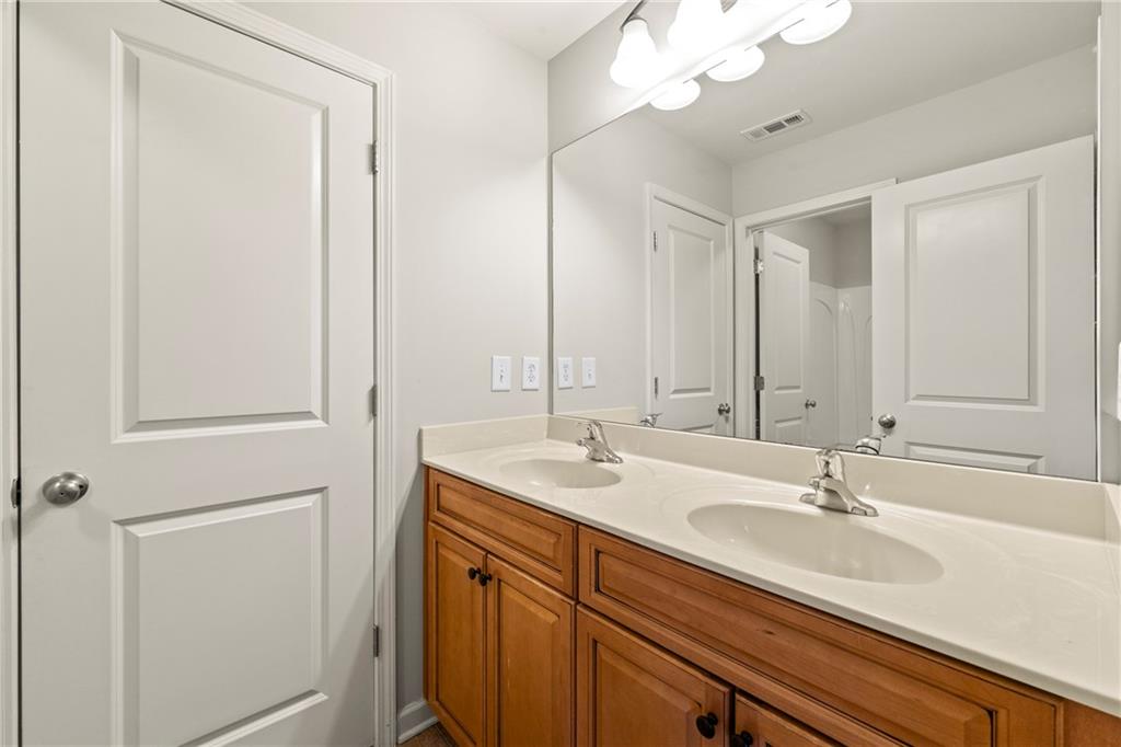 3181 Day Break Lane Dacula, GA 30019 - Photo 16 of 25 a bathroom with a sink and a mirror
