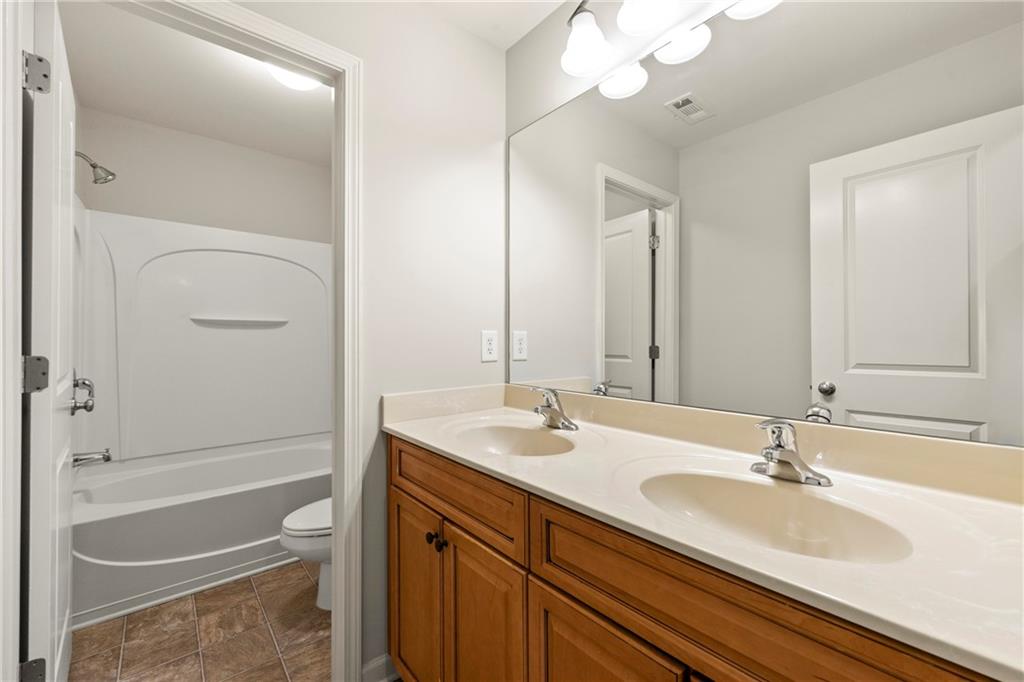 3181 Day Break Lane Dacula, GA 30019 - Photo 17 of 25 a bathroom with a sink a toilet and shower