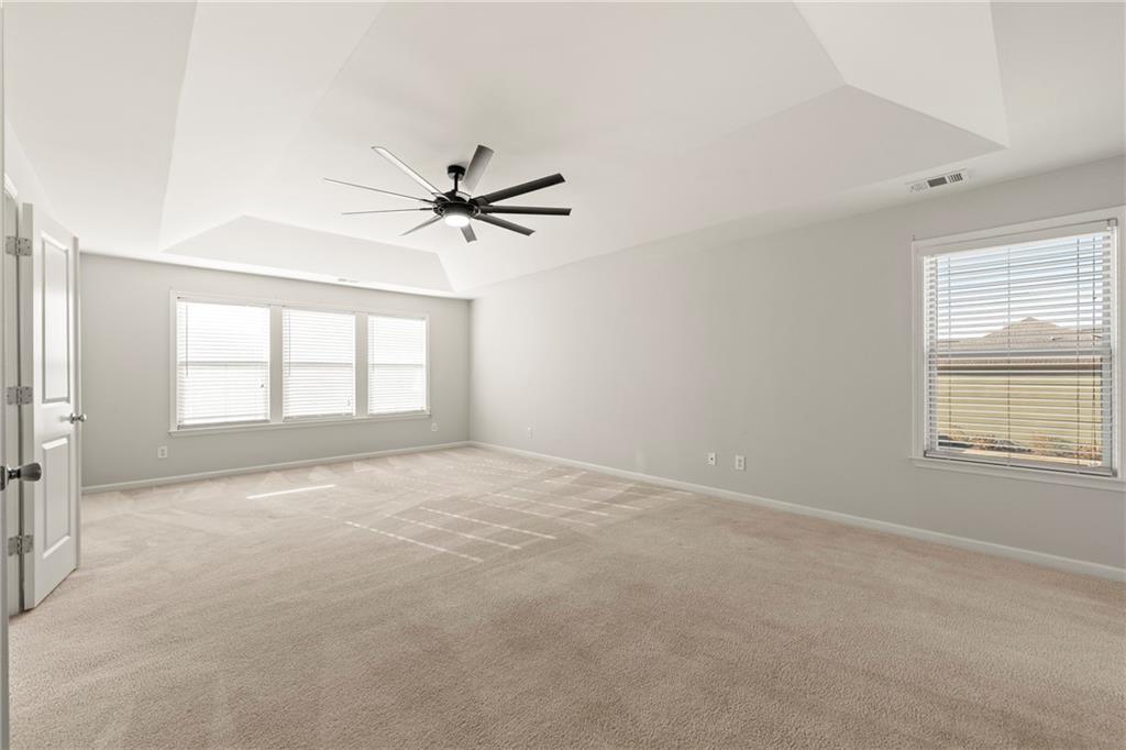 3181 Day Break Lane Dacula, GA 30019 - Photo 18 of 25 an empty room with windows and ceiling fan