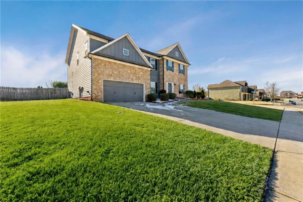 3181 Day Break Lane Dacula, GA 30019 - Photo 2 of 25 a front view of a house with a yard