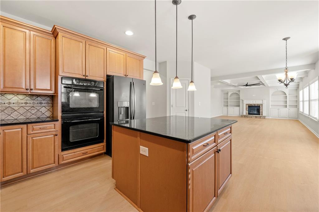 3181 Day Break Lane Dacula, GA 30019 - Photo 4 of 25 a kitchen with stainless steel appliances granite countertop a refrigerator a oven and a sink with cabinets