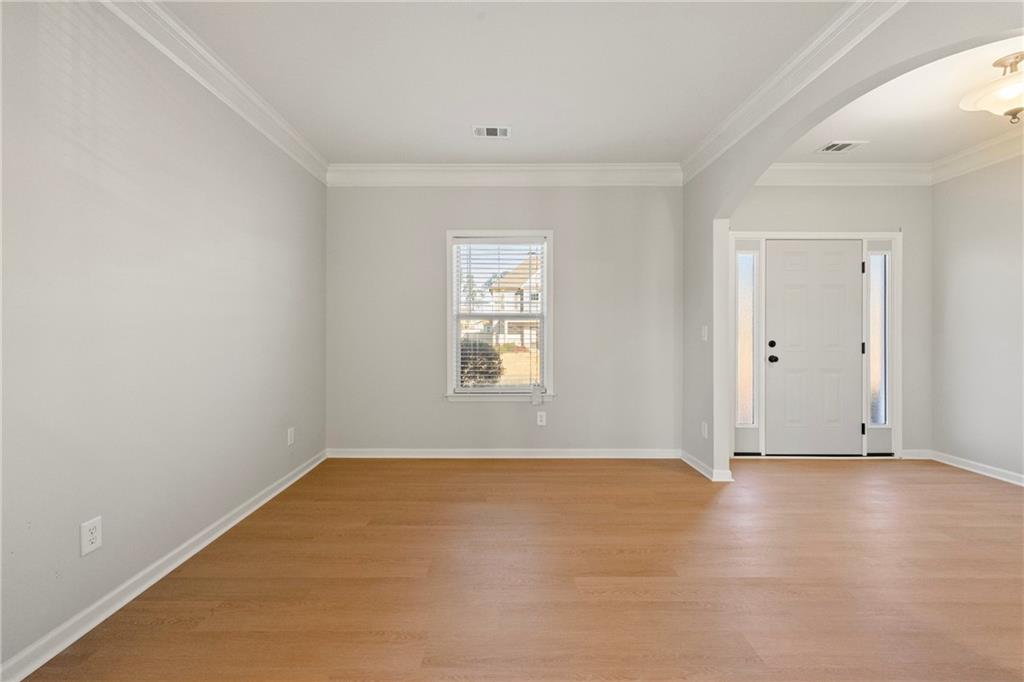 3181 Day Break Lane Dacula, GA 30019 - Photo 5 of 25 a view of an empty room with wooden floor and a window