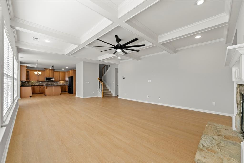 3181 Day Break Lane Dacula, GA 30019 - Photo 7 of 25 a view of a livingroom with a ceiling fan and wooden floor