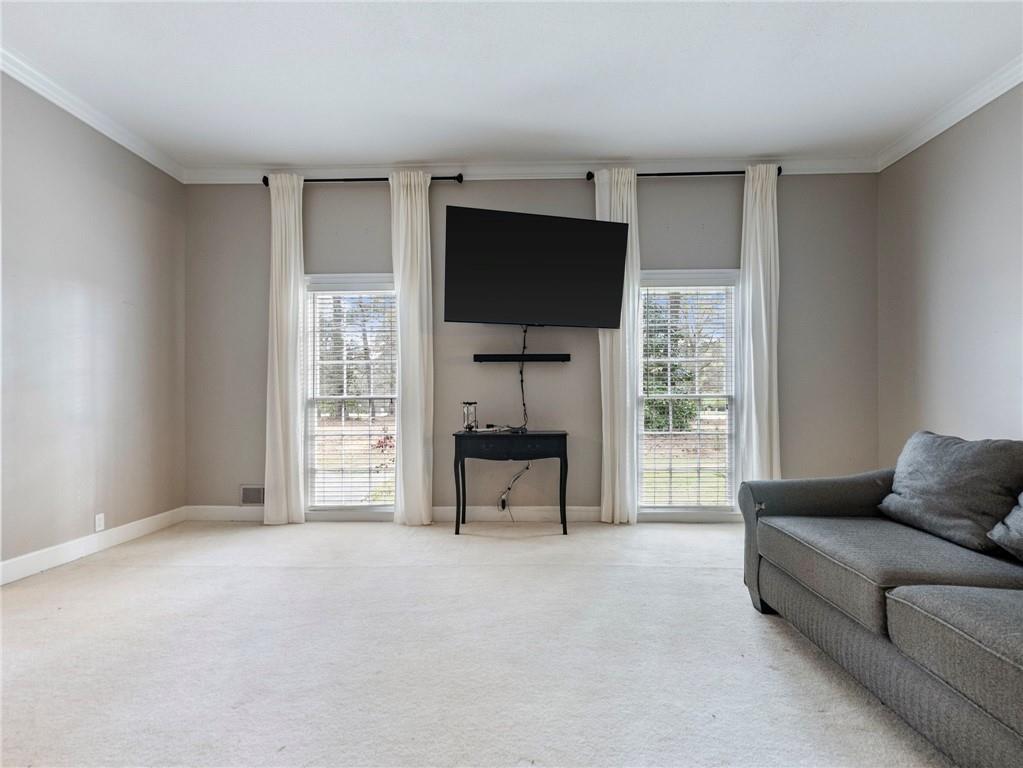 945 Poplar Street Monroe, GA 30655 - Photo 12 of 55 a living room with furniture and a flat screen tv
