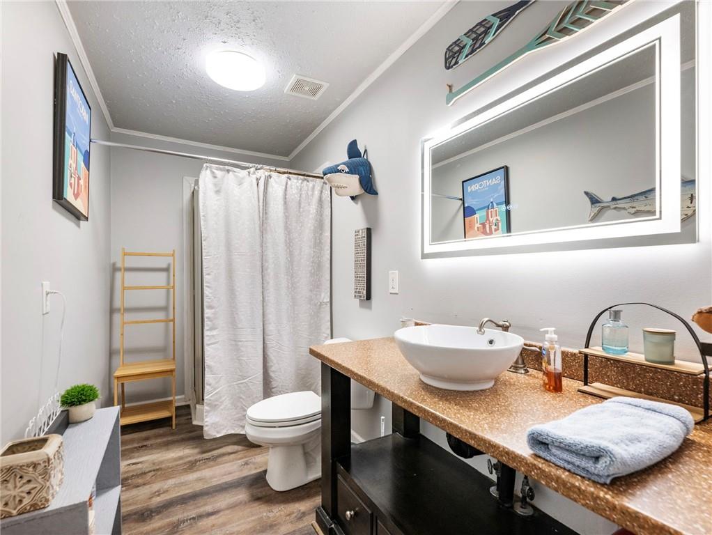 945 Poplar Street Monroe, GA 30655 - Photo 17 of 55 a bathroom with a toilet sink and mirror